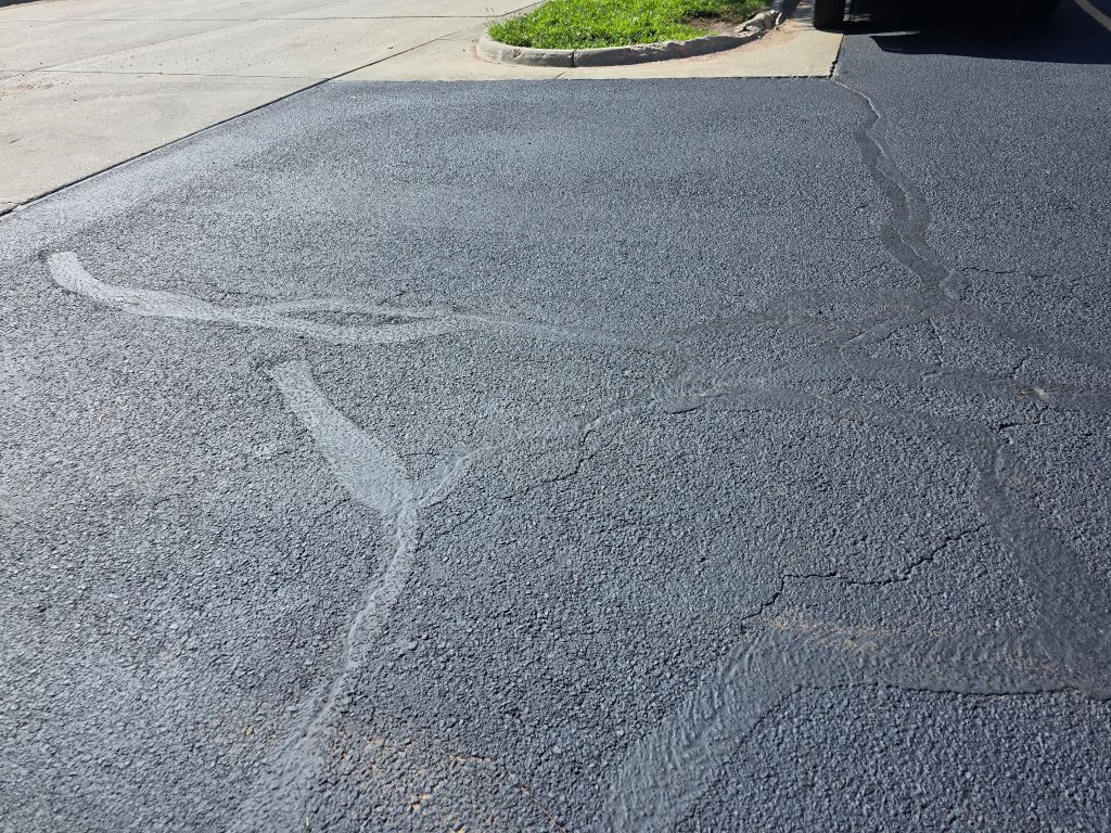 Hot rubberized crack fill applied to asphalt