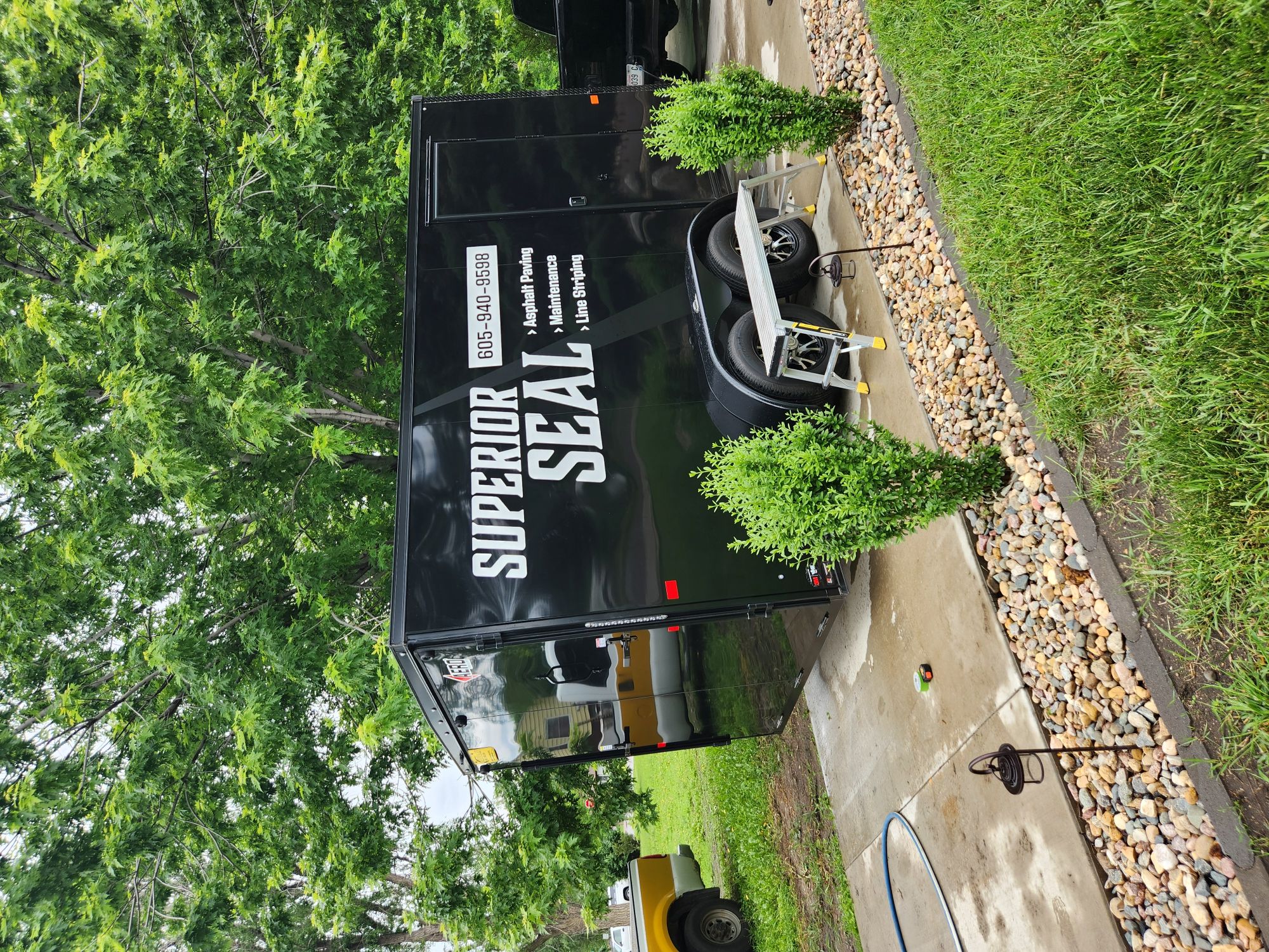 The Superior Seal company trailer on a finished asphalt driveway